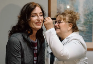 DeAnna and a patient at Prime Care, LLC, 5417 Johnson Drive, Mission, KS 66205 is looking in her ear.